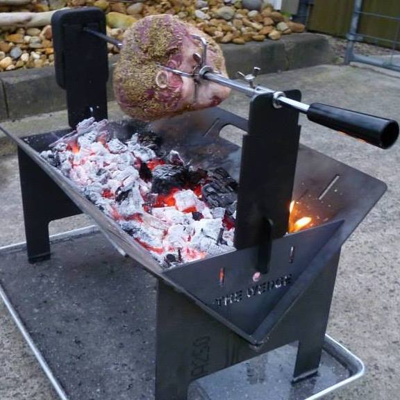 This photo shows a Pork Cooking on a Spit Roaster